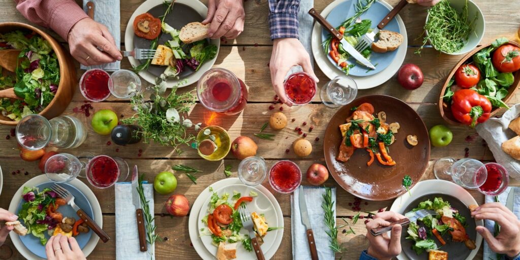 people sitting at a dining table eating