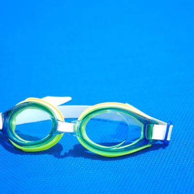 sport goggles on a blue pad