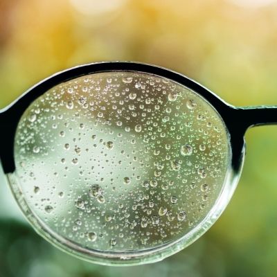 glasses with rain drops on the lens