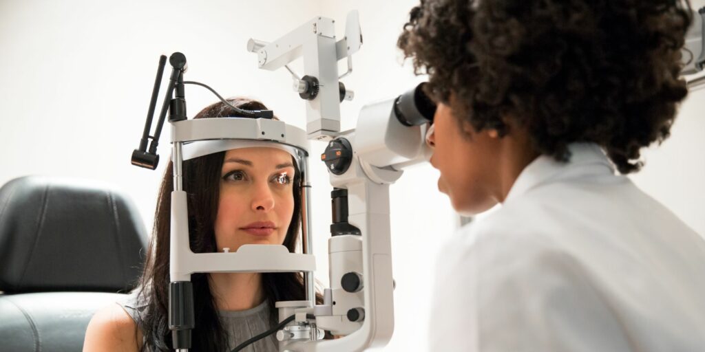 Woman receiving an eye exam from her optometrist.