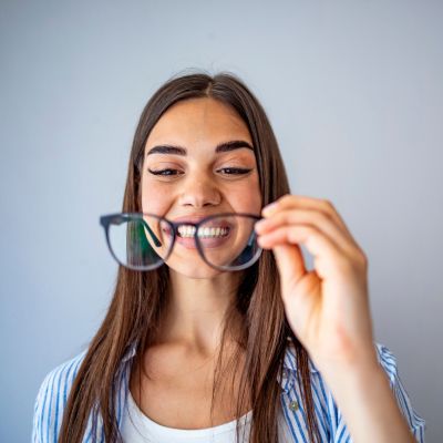 Young woman smiling at her new eyeglasses