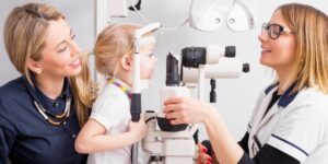 child visiting an optometrist to get her eyes checked