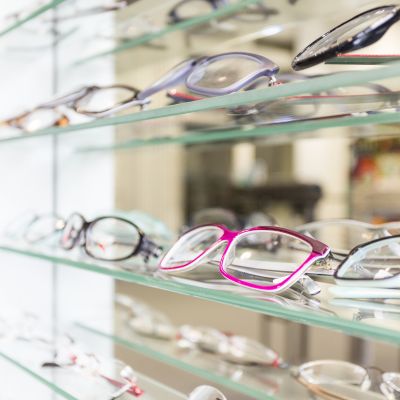 a mirrored display case of same-day glasses