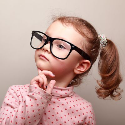 little girl in oversized glasses thinking and looking serious