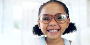 smiling little girl wearing glasses