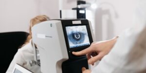 optometrist checking a patient for an eye disease that causes blindness